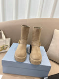 Prada women's suede ankle boots in beige, with side straps and chunky lug soles.