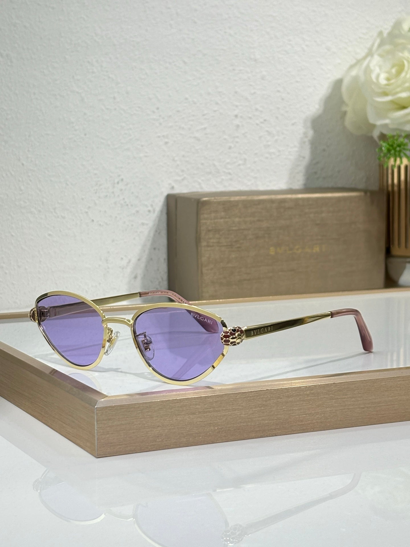 Bvlgari glasses with gold-tone metal frame and purple-tinted cat-eye lenses