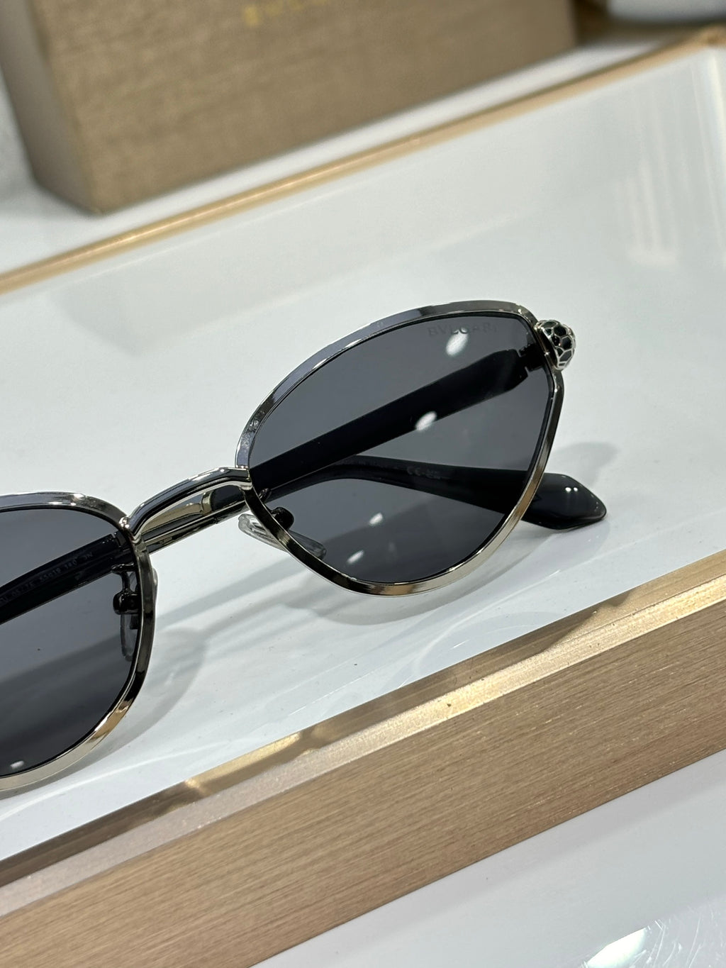 Bvlgari glasses with dark cat-eye lenses and black outer frame on display