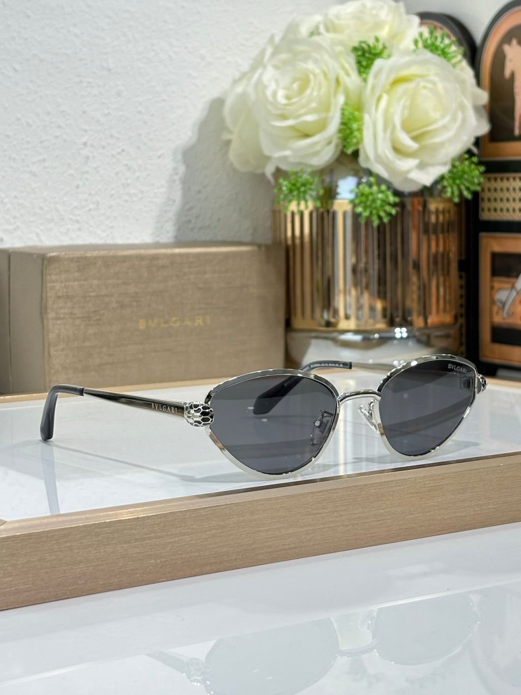 Bvlgari glasses set with dark round lenses and metal frames on display