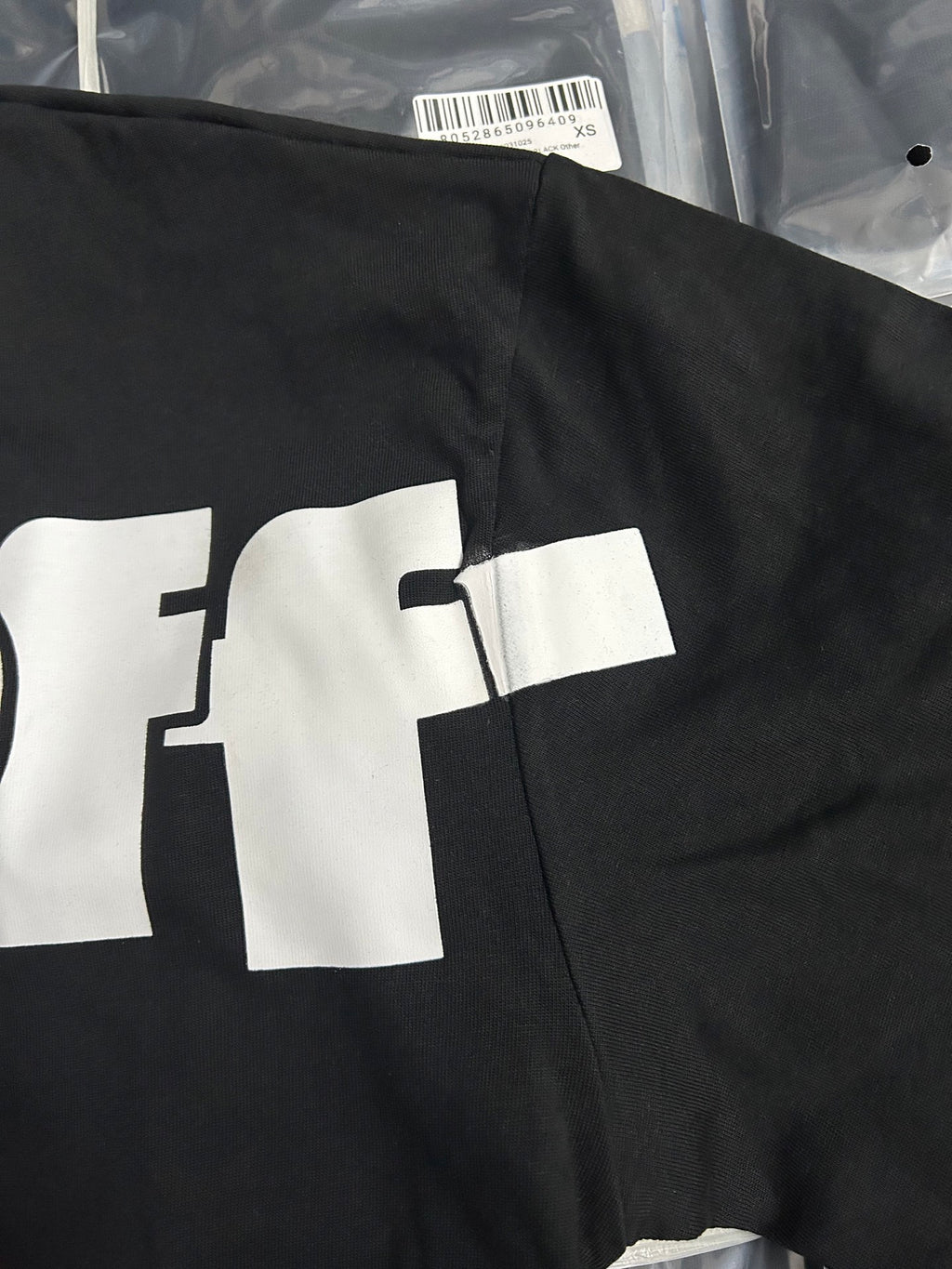 Black Off-White T-shirt showing partial white 'OFF' logo on the chest