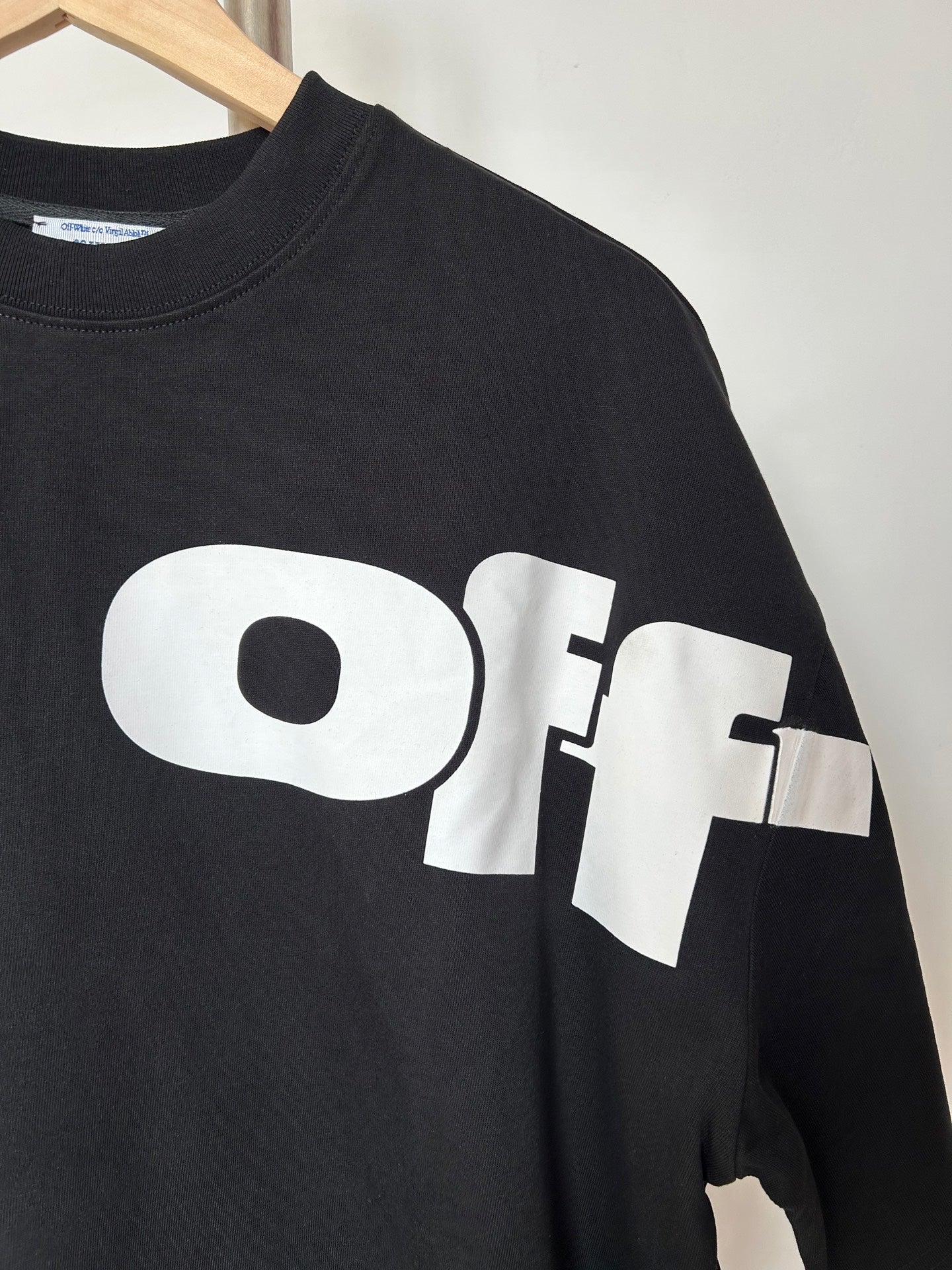 Off White T-shirt close-up, black with white 'Off' graphic across front
