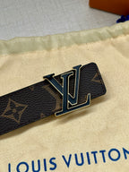 LV belt buckle on dark monogram canvas strap with gold-tone hardware and black leather.