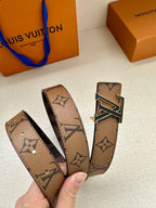 Louis Vuitton monogram belt strap held in hand with gold-tone LV buckle