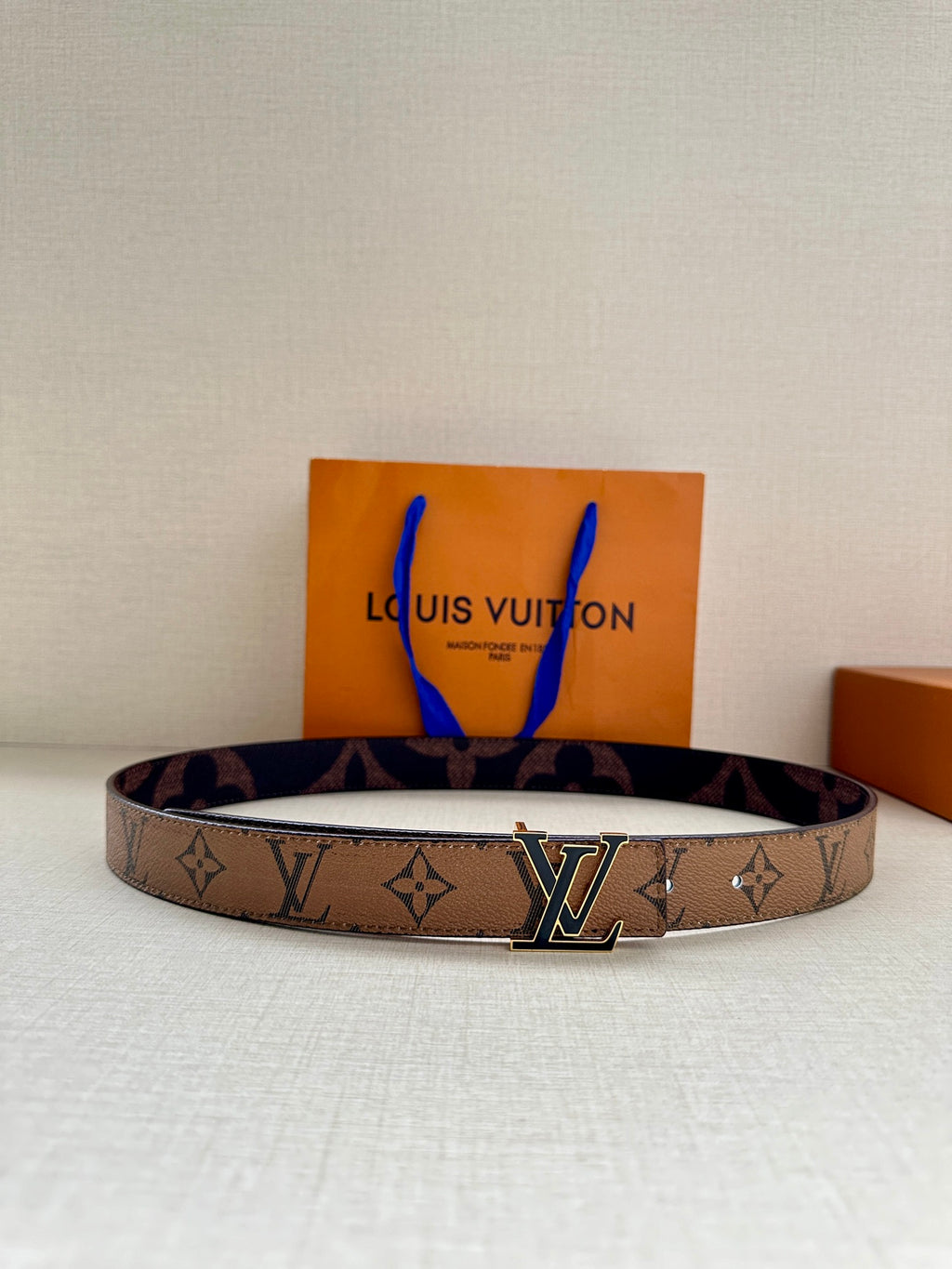 Louis Vuitton monogram belt with gold-tone LV buckle and dark brown strap