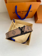 Louis Vuitton monogram belt with gold-tone LV buckle on cream pouch