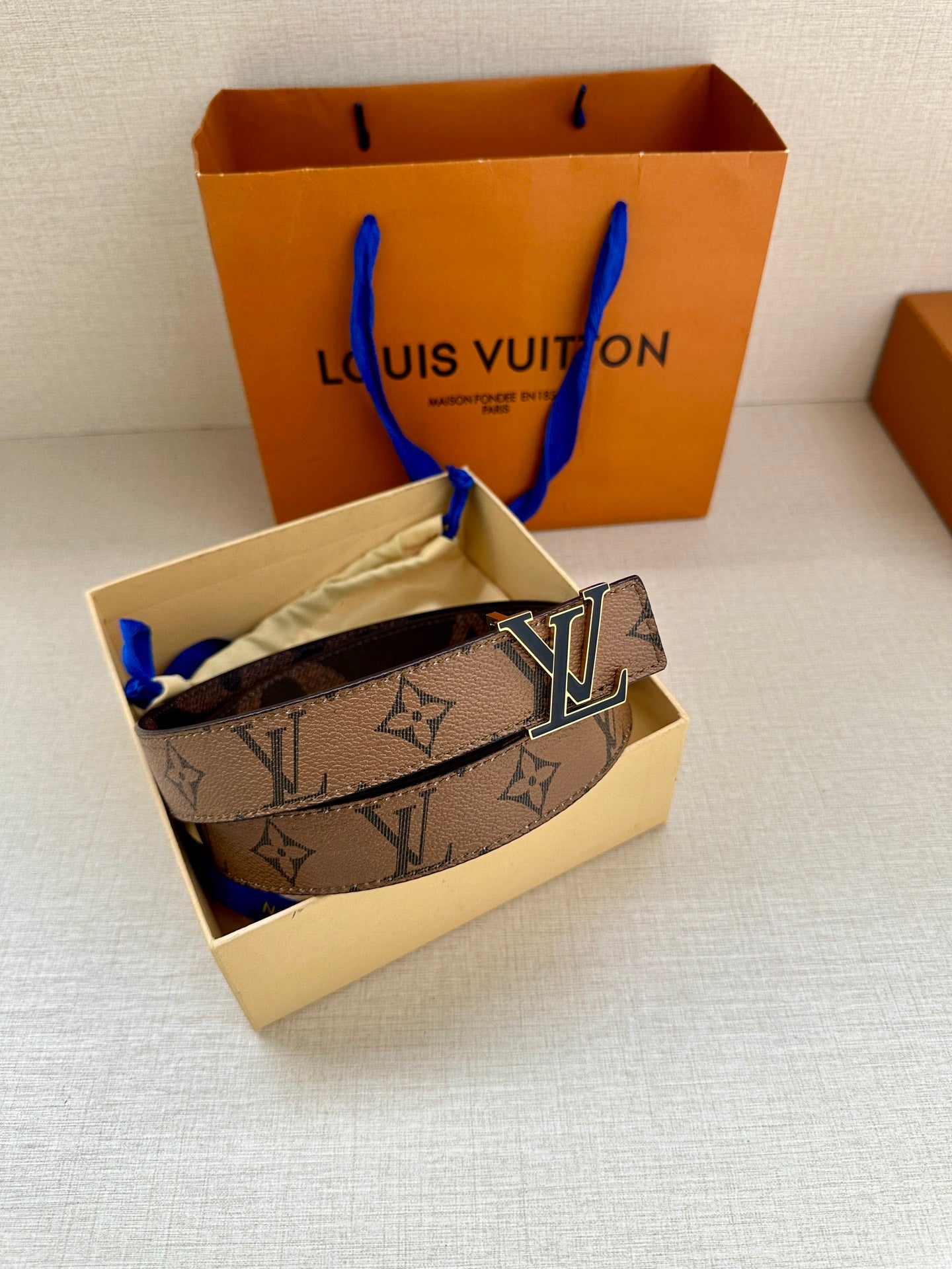 Louis Vuitton monogram belt in gift box with gold-tone LV buckle and dark strap