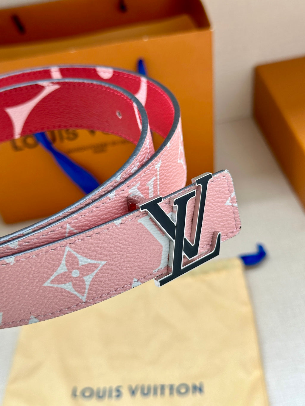 Pink monogram belt close-up showing silver LV buckle on strap