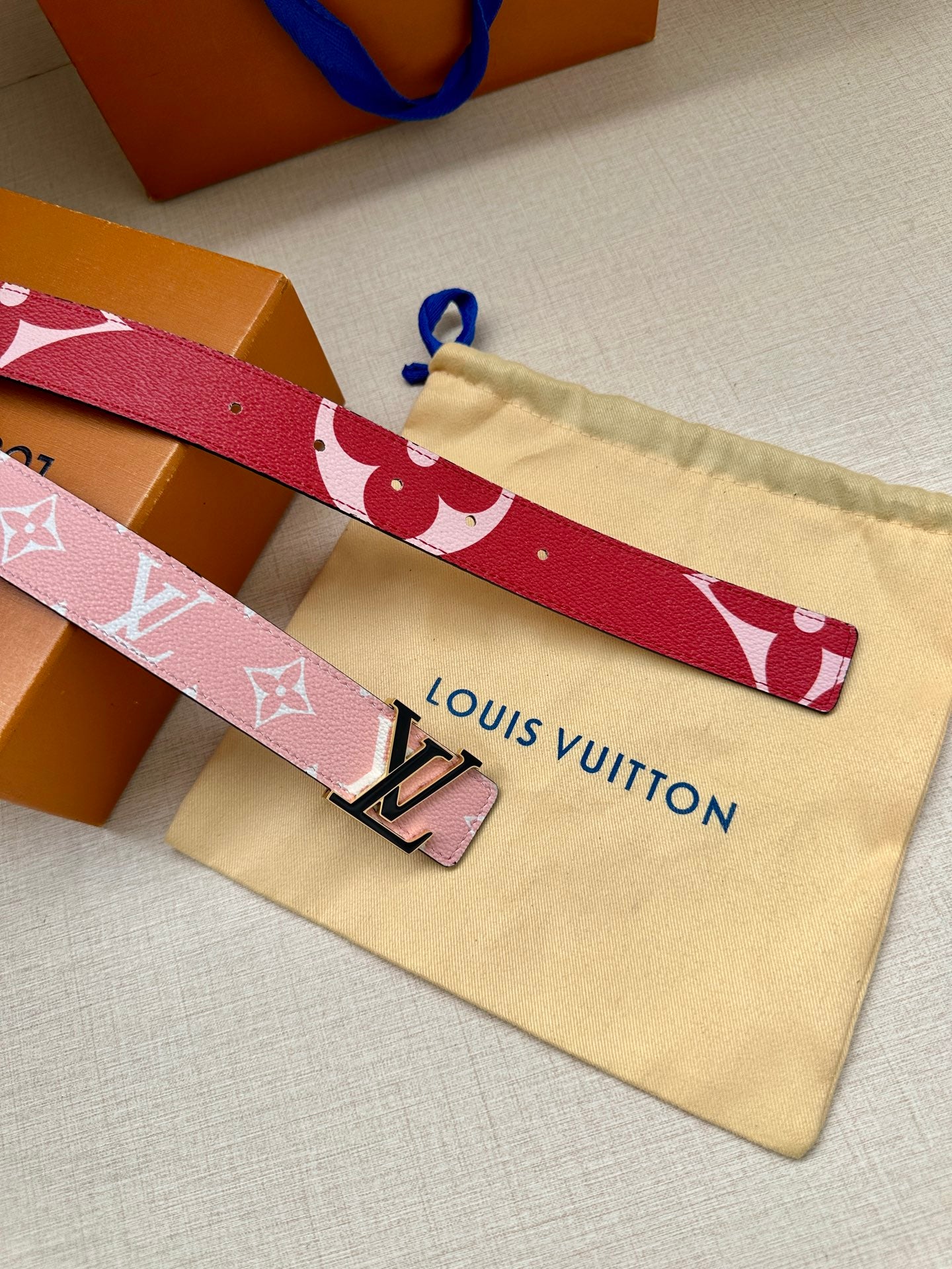 Pink monogram belt with silver LV buckle and blue pull cord