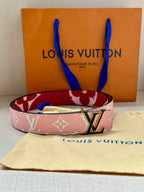 Pink monogram belt with silver LV buckle resting on dust bag