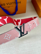 Pink monogram belt with large silver LV buckle, close-up view