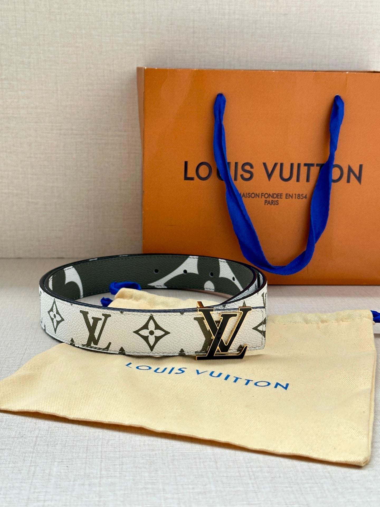 Louis Vuitton belt with white monogram strap and dark green edge, silver LV buckle