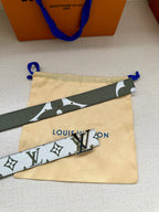 Louis Vuitton belt with white monogram strap, dark green trim, silver LV buckle