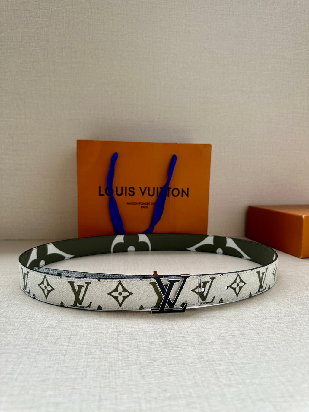 Louis Vuitton belt: white monogram canvas with dark green trim and silver LV buckle