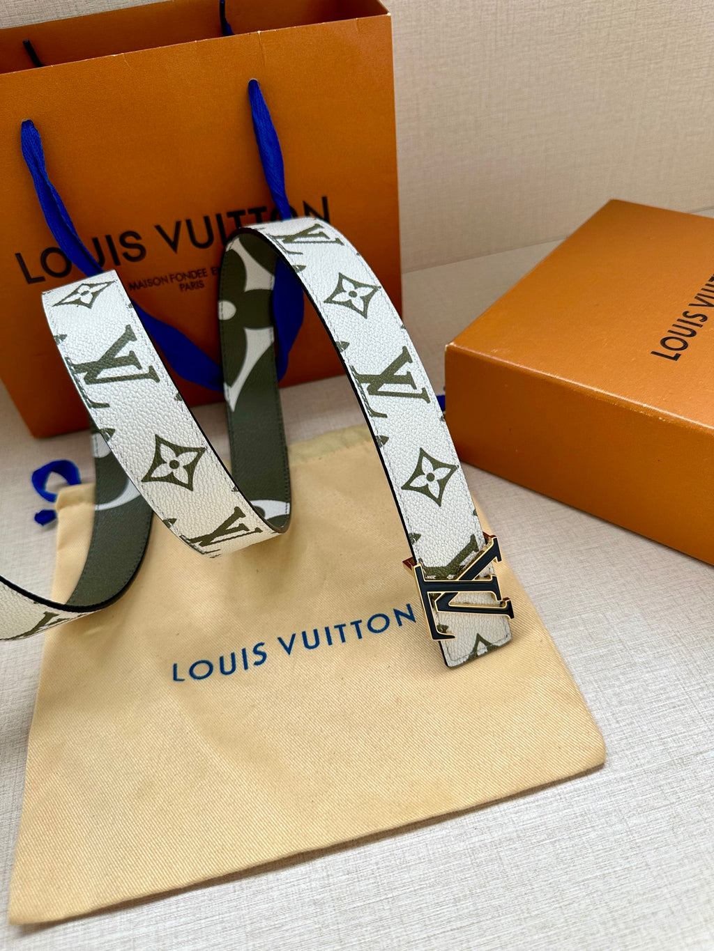 Louis Vuitton belt: white monogram strap, dark green underside, silver LV buckle