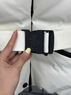 White puffer jacket with hood toggle-style belt and snap buttons, close-up