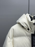 White hooded puffer jacket with front buttons and black trim near the zipper