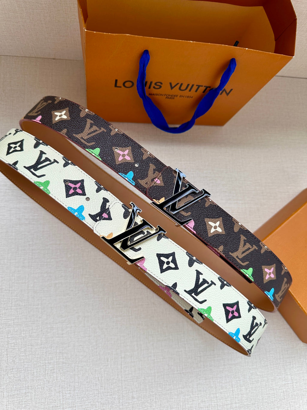 Leather LV monogram belt with multicolor print and gold-tone buckle, side view