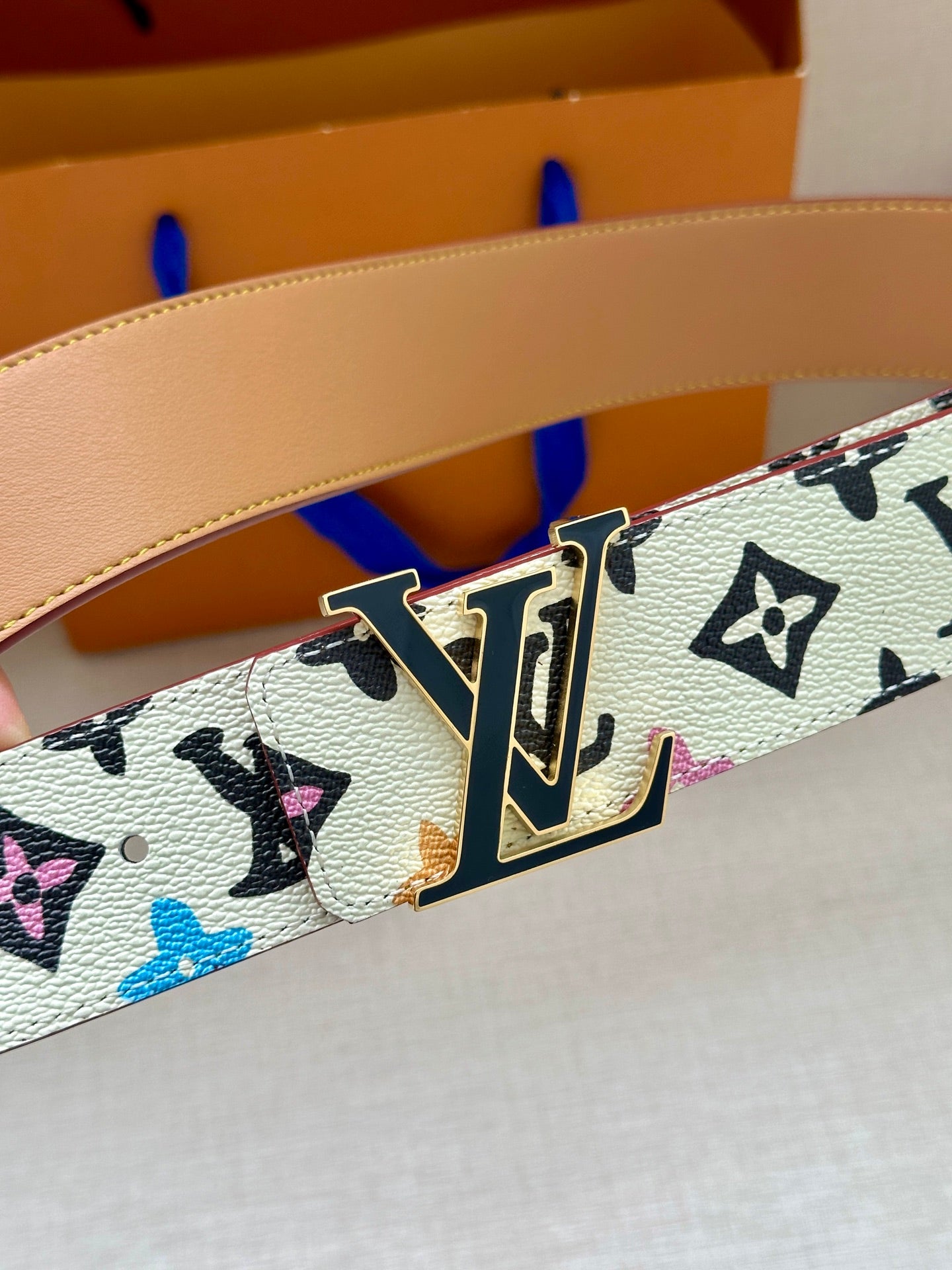 Leather belt detail with multicolor LV monogram and gold buckle bar
