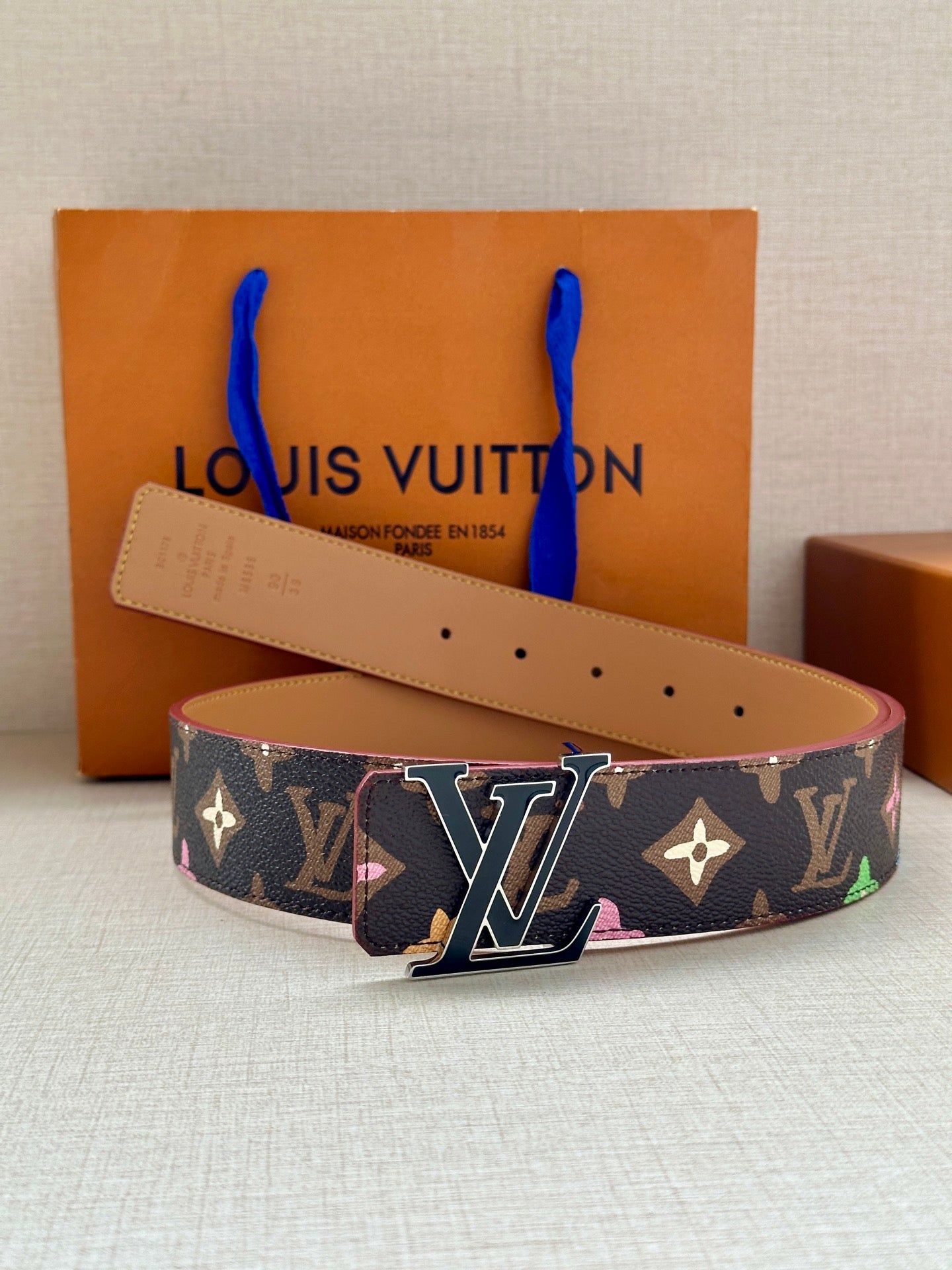 Designer belt in navy monogram canvas with multicolor motifs and silver LV buckle