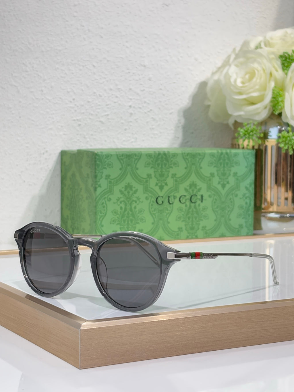 Gucci round sunglasses with dark lenses and black frame with silver-toned temples