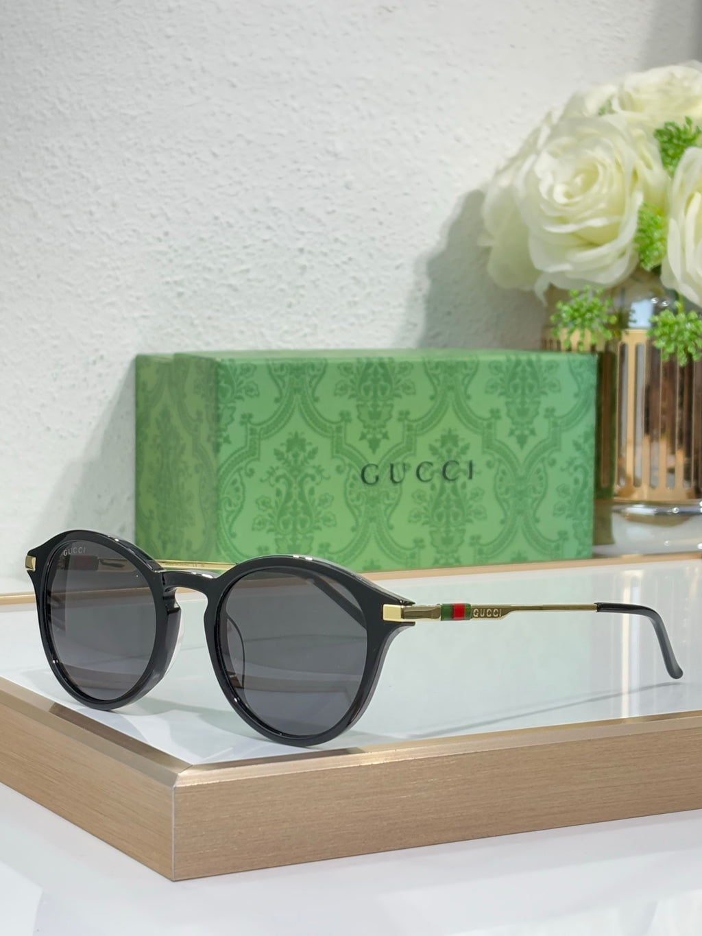 Gucci round sunglasses with dark lenses and black frame with thin metal arms