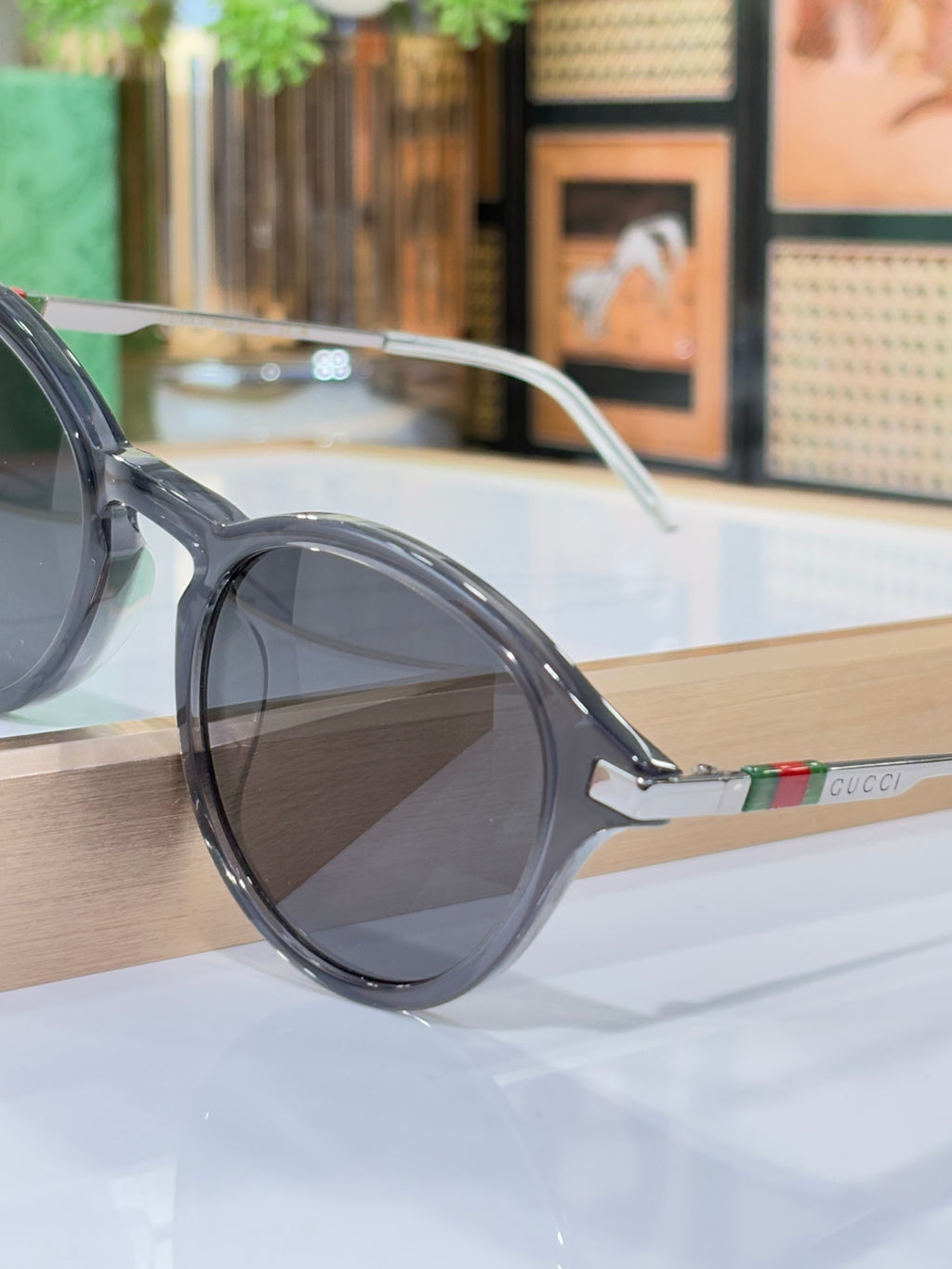 Gucci round sunglasses with dark lenses and smoky gray frame with metal arm