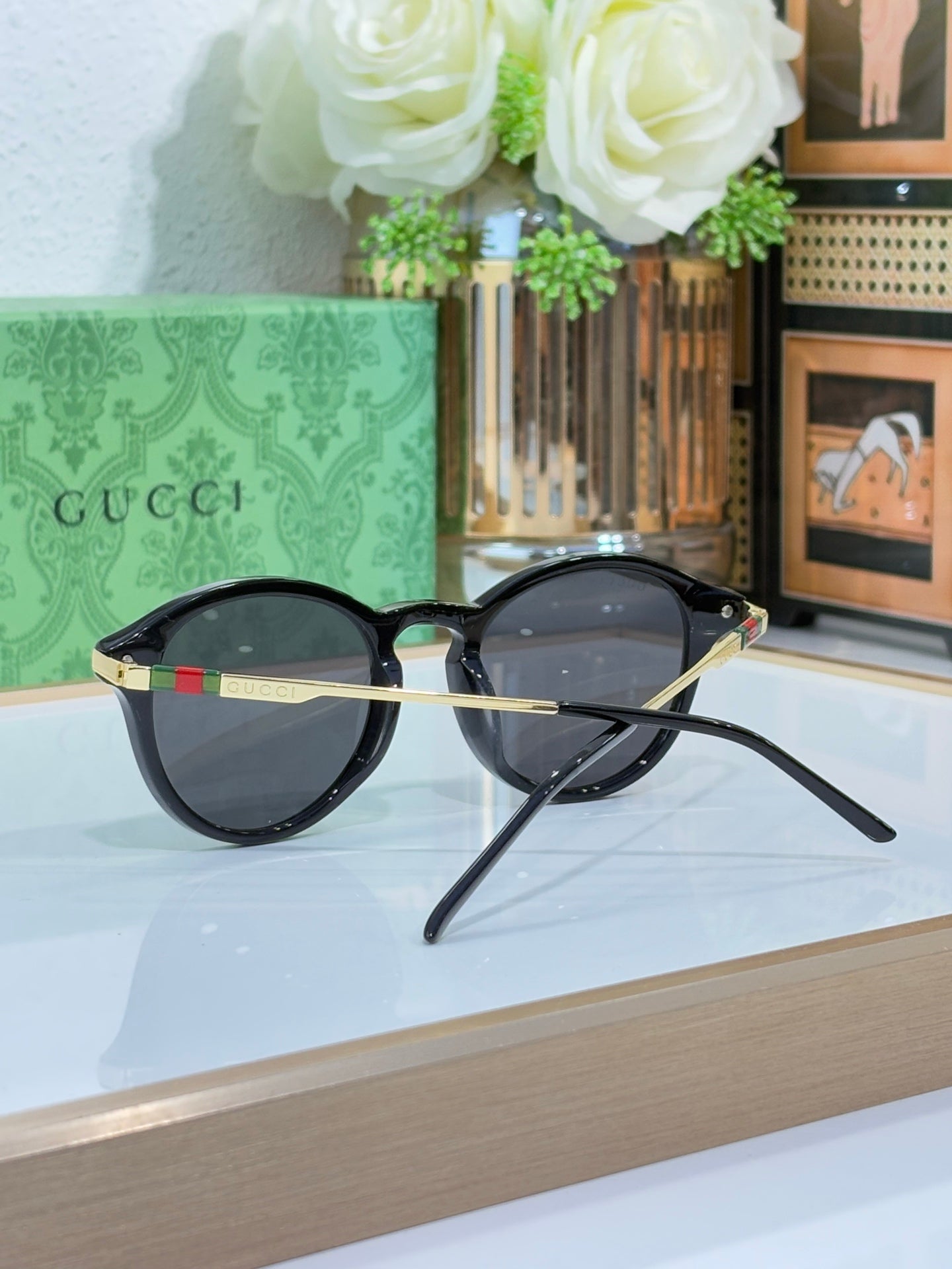 Gucci round sunglasses with dark lenses and black frame with metal temples