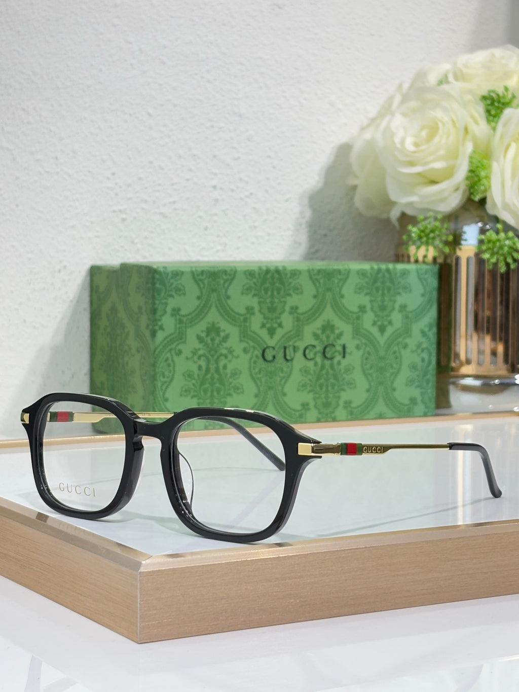 Gucci eyeglasses with dark frames and tortoise-tone top rims, clear lenses