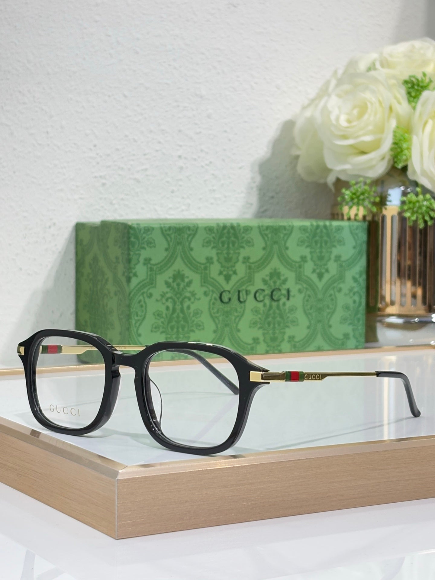 Gucci eyeglasses with dark frames and tortoise-tone top rims, clear lenses