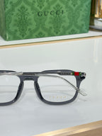 Gucci eyeglasses side view with dark frame and temple stripe, clear lenses
