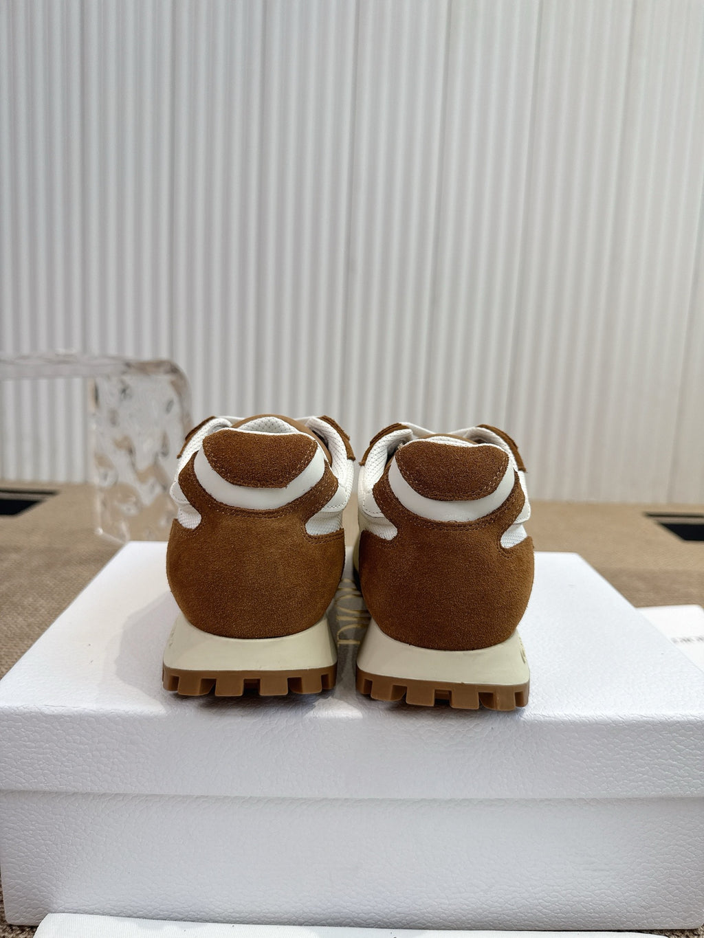 Dior unisex sneakers back view, brown suede heels with white top trim.