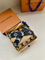 Louis Vuitton belt laid flat with dark blue strap and repeating white logo motifs