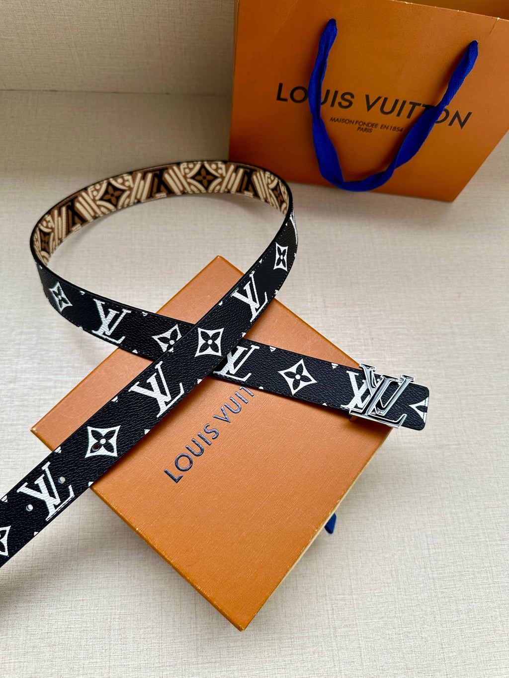 Louis Vuitton belt with dark blue strap and white LV monogram with star motifs