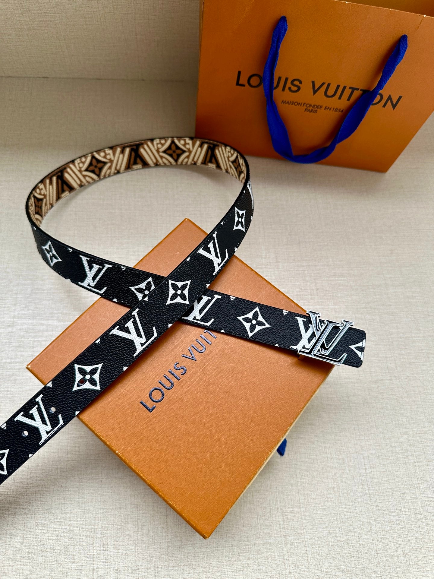 Louis Vuitton belt with dark blue strap and white LV monogram with star motifs