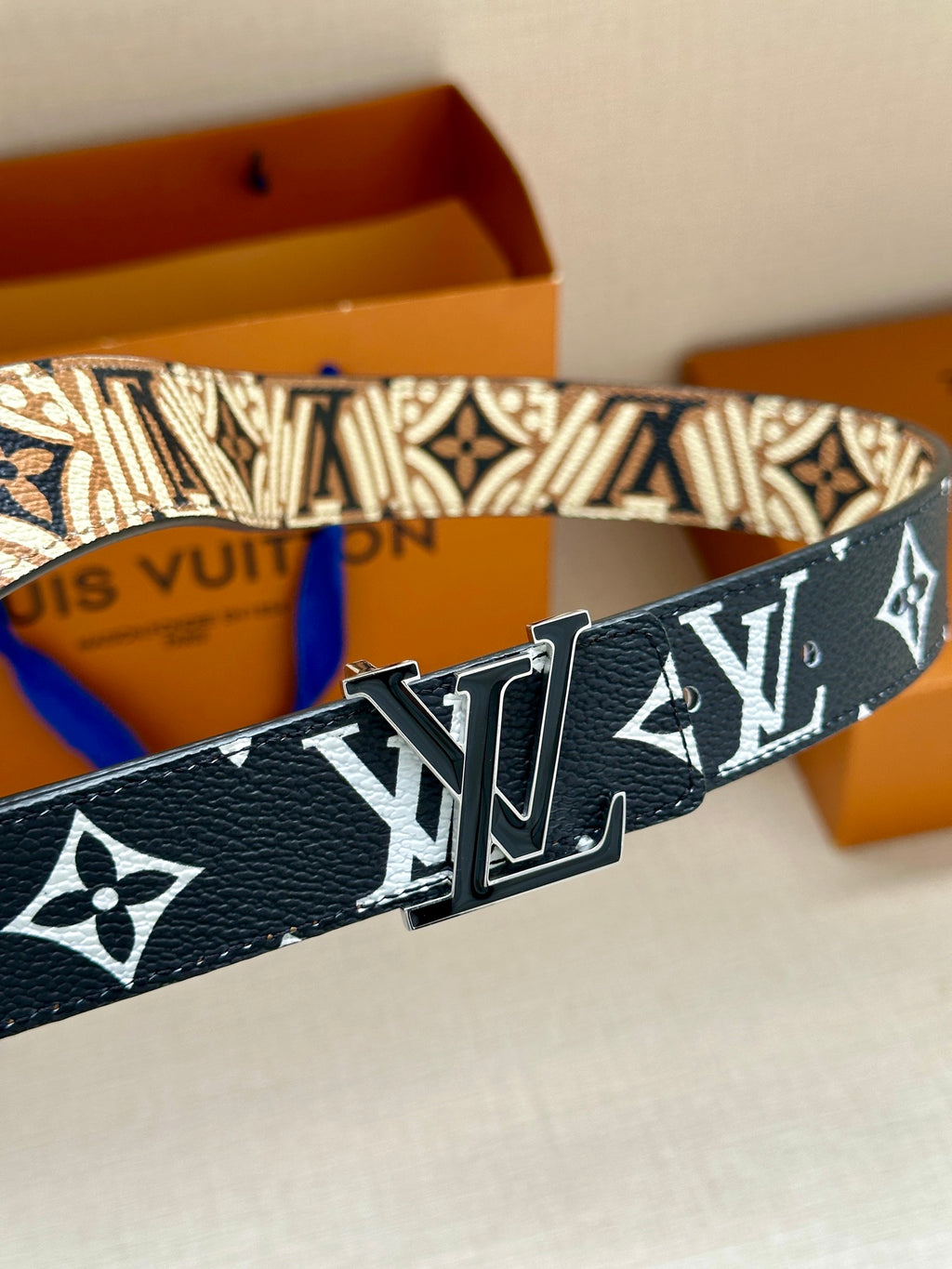Louis Vuitton belt with dark blue patterned strap and silver-tone buckle