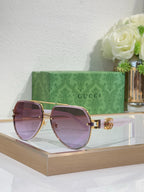 Gucci sunglasses with gold-tone frames and purple-tinted gradient lenses