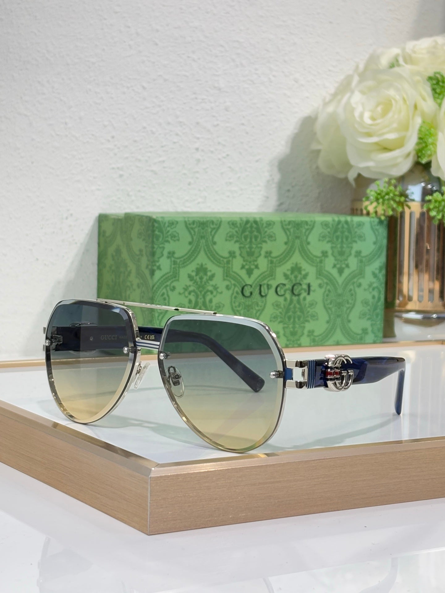 Gucci sunglasses with gold-tone frames and dark gradient lenses, large oval