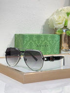 Gucci sunglasses with gold-tone frames and dark-to-light gradient lenses