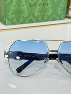 Gucci eyeglasses with rounded blue-tinted lenses and silver bridge