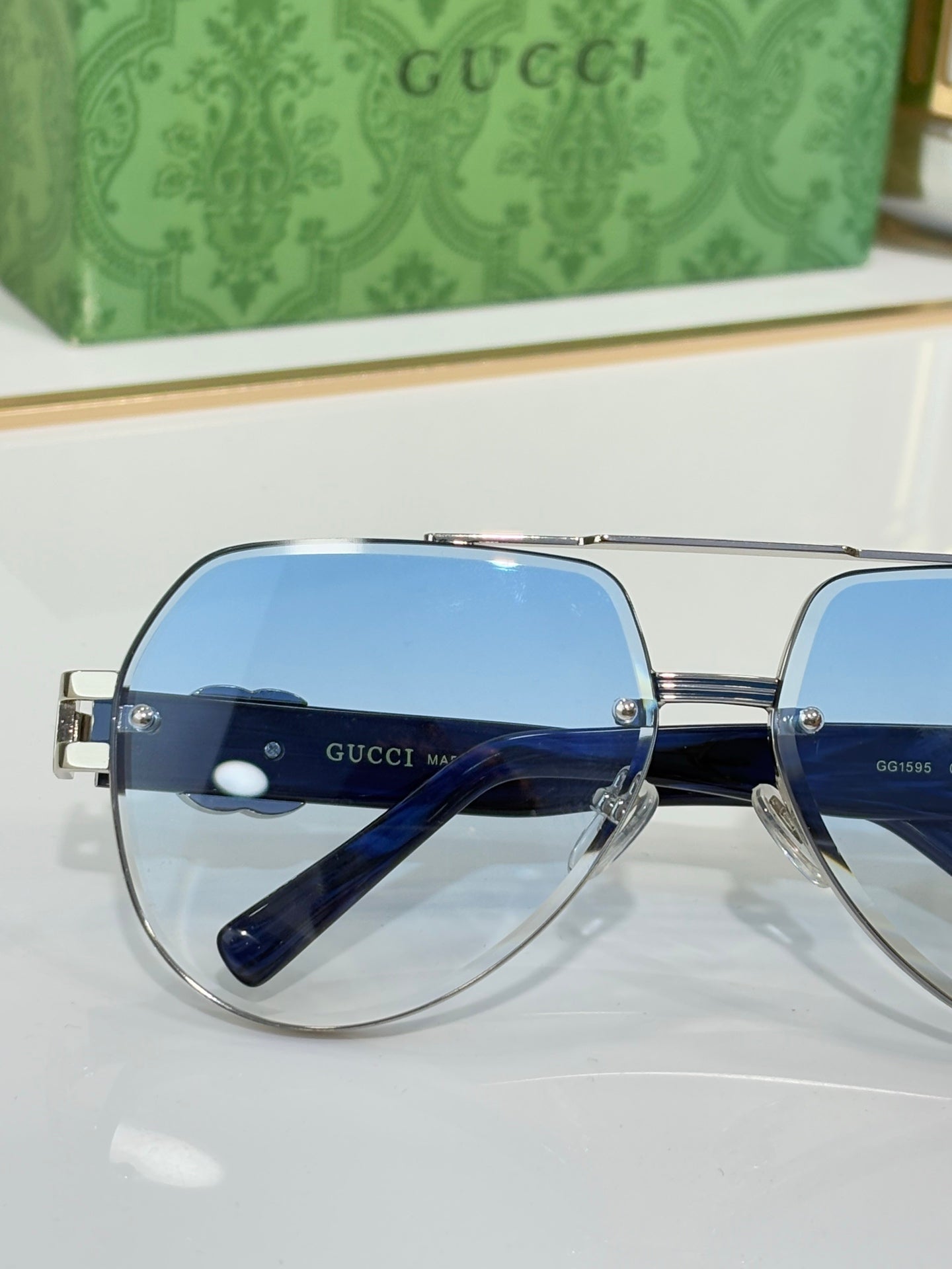 Gucci eyeglasses with rounded blue-tinted lenses and silver bridge