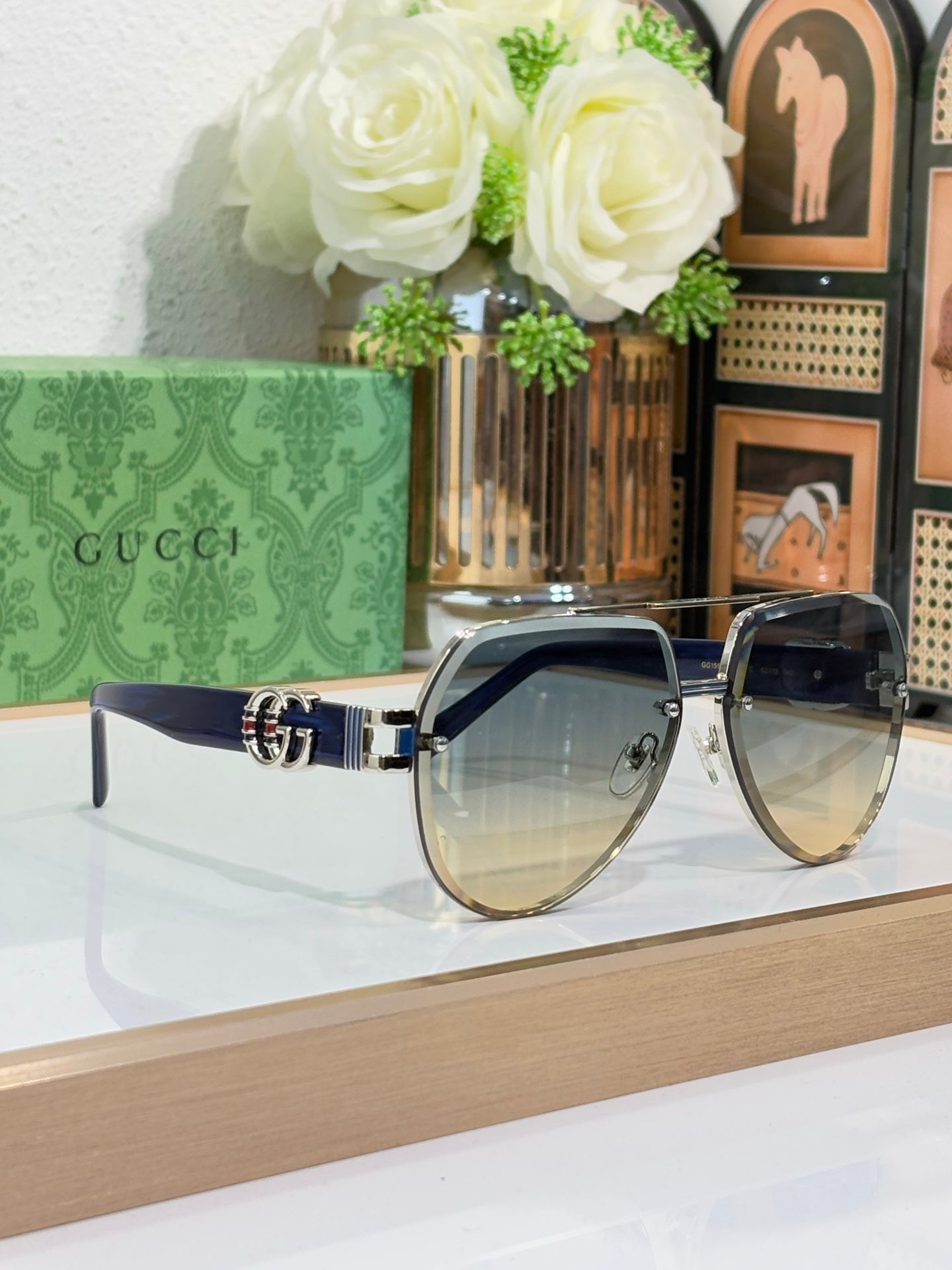 Gucci eyeglasses with silver rims, blue-tinted lenses, and dark temples