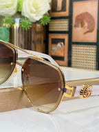 Gucci eyeglasses with gold frames and brown-tinted lenses with logo detail