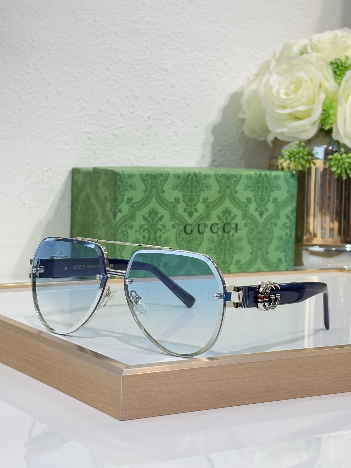 Gucci eyeglasses with silver metal frames and blue-tinted lenses