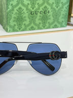 Gucci eyeglasses with dark temple arms and GG-style logo detail