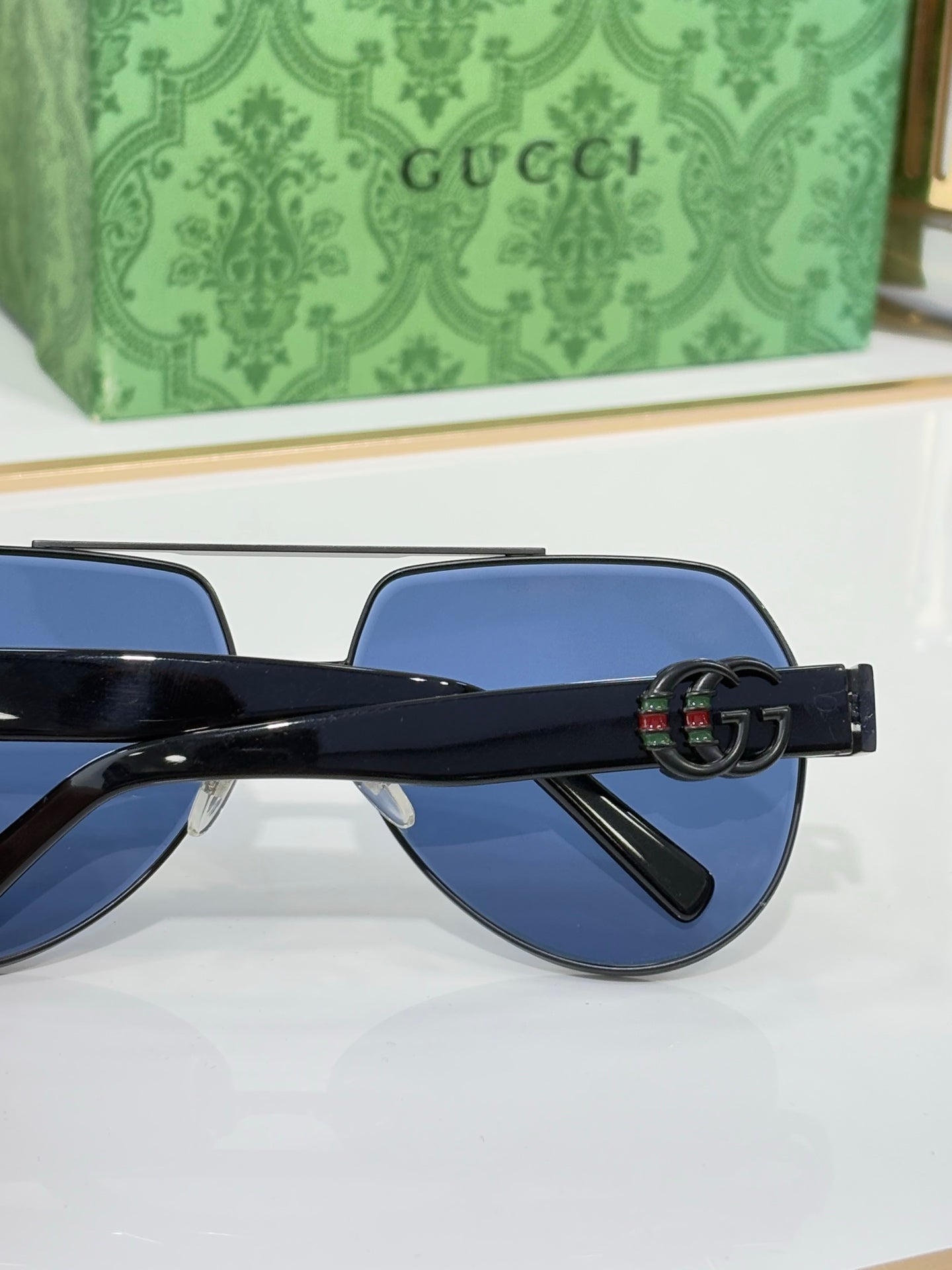 Gucci eyeglasses with dark temple arms and GG-style logo detail