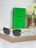 Sunglasses with gold frame and dark gray lenses, front view