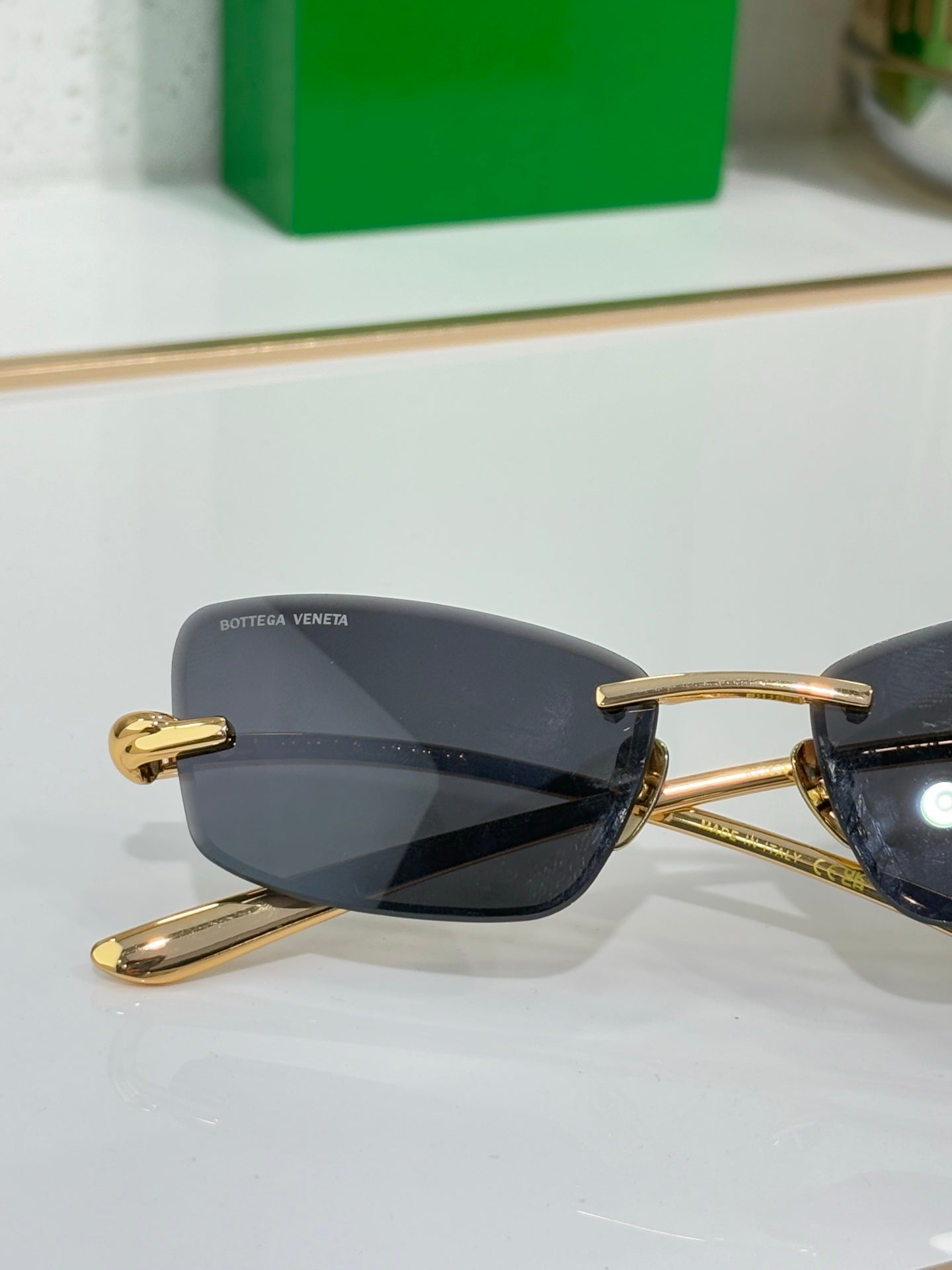 Sunglasses close-up with dark lenses and gold frame arms