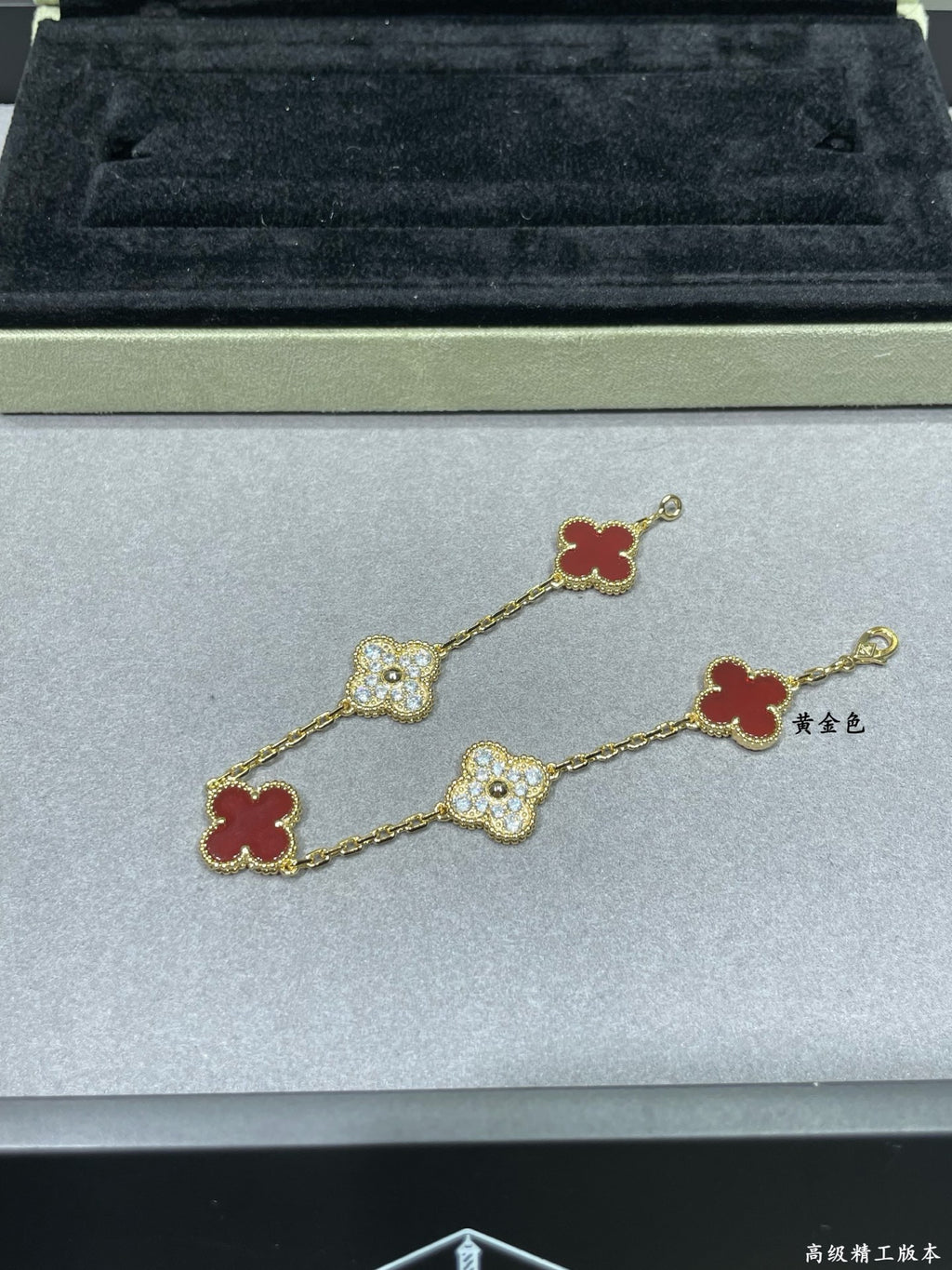 Gold-tone clover bracelet with red enamel and pavé quatrefoil charms
