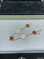 Gold-tone clover bracelet with red enamel and pavé quatrefoil charms